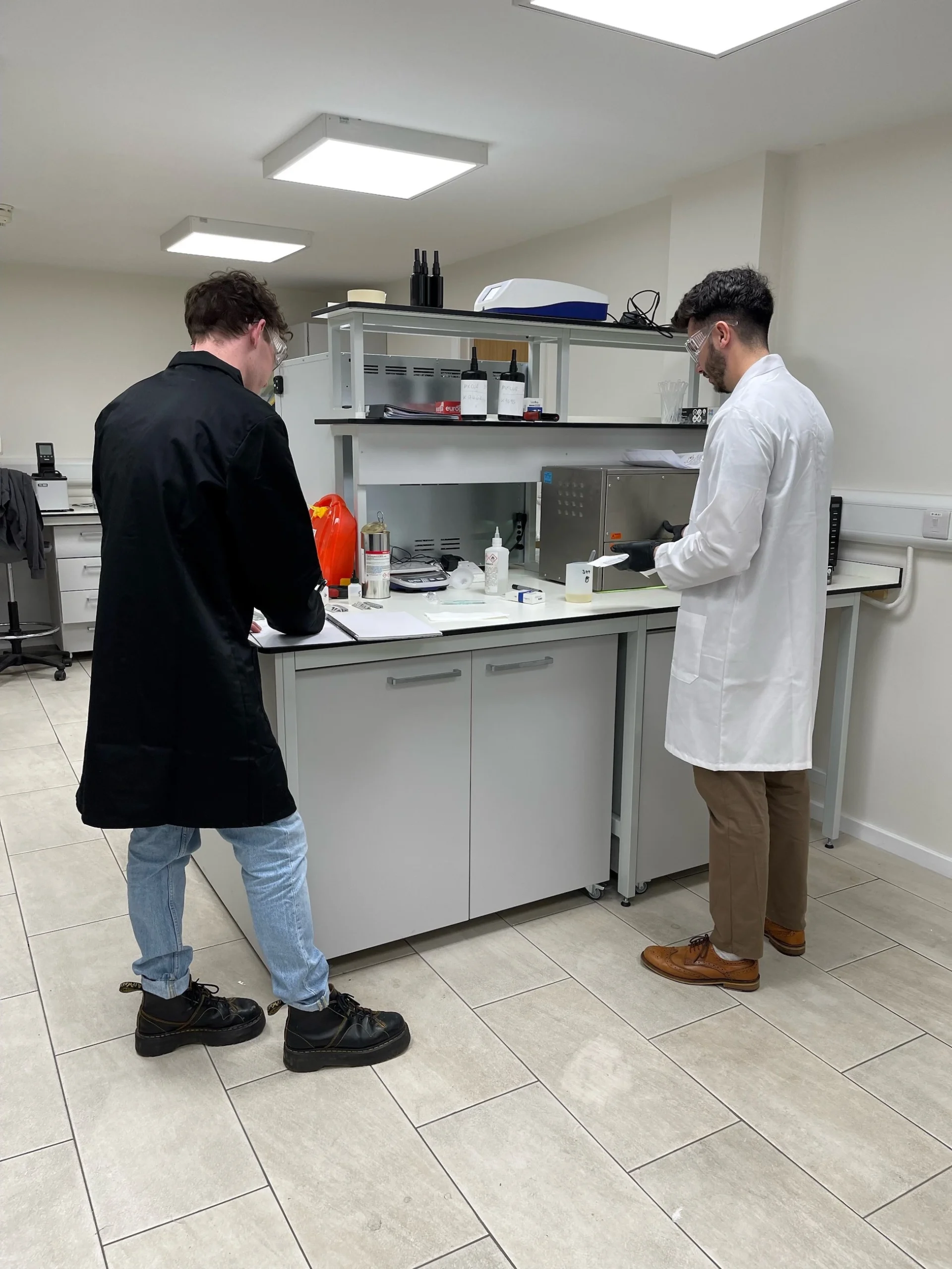 Two men working in a laboratory at Cartell UK